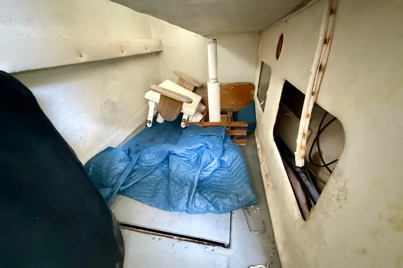 Slide: The Image of Interior of a 2000 BAJA CRUISER King Cat 340 boat, showing storage area. - 54