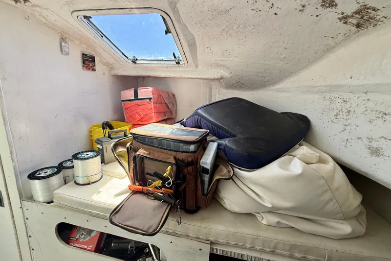 Slide: The Image of Interior of 2000 BAJA CRUISER King Cat 340 with fishing gear and supplies. - 56