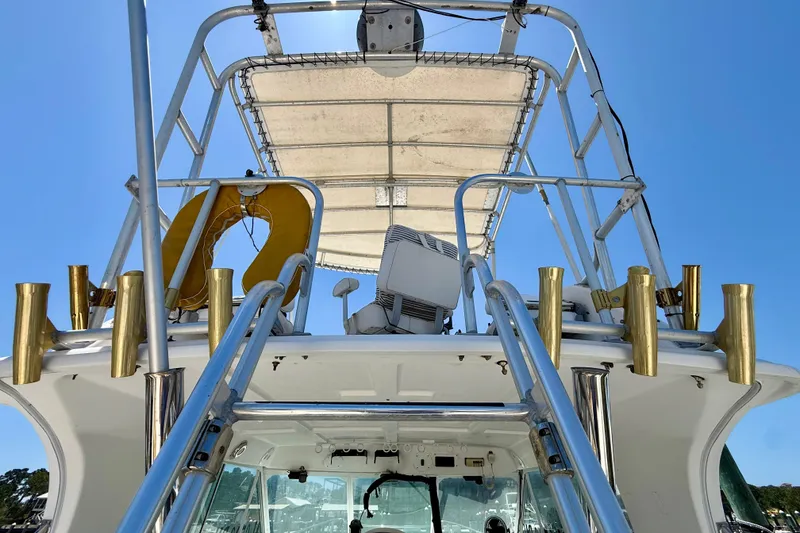 Slide: The Image of 2000 BAJA CRUISER King Cat 340 boat with upper deck and fishing rod holders. - 58