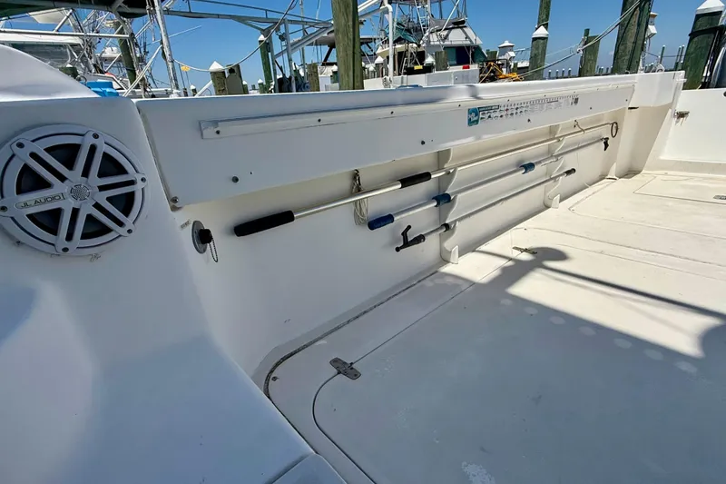 Slide: The Image of 2000 BAJA CRUISER King Cat 340 boat deck with fishing rod holders and JL Audio speaker. - 66