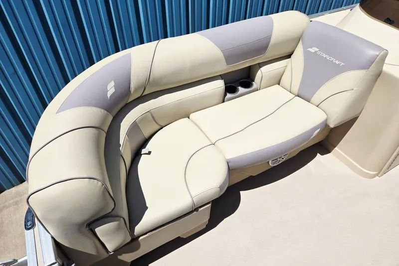 Slide: The Image of 2019 Starcraft EX 20 C boat seating with beige and gray upholstery, featuring cup holders. - 12