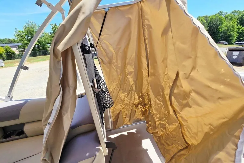 Slide: The Image of 2019 Starcraft EX 20 C boat interior with beige canopy and seating. - 14