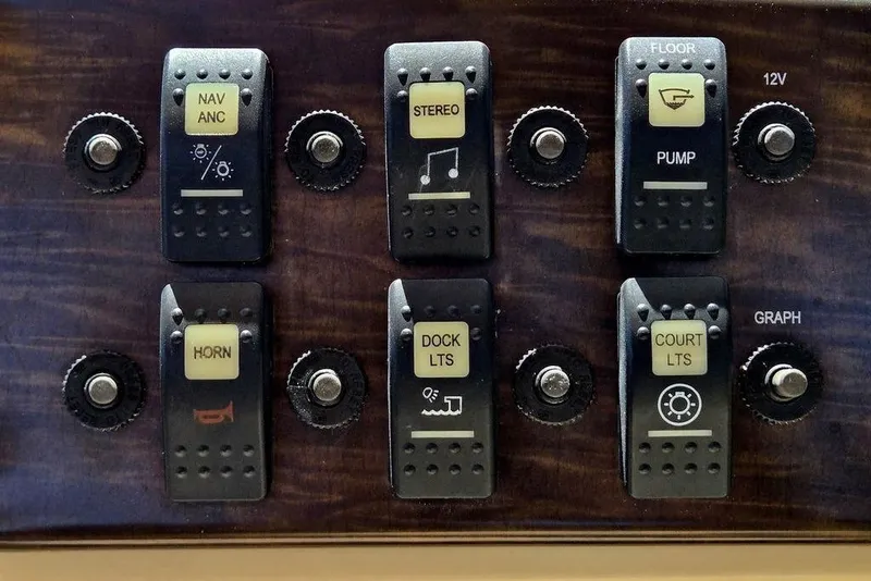 Slide: The Image of Control panel of a 2019 Starcraft EX 20 C boat with labeled switches and knobs. - 15