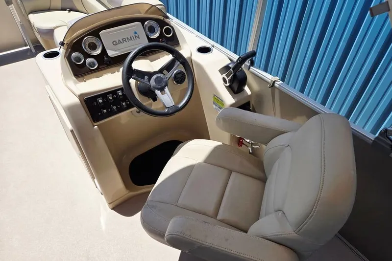 Slide: The Image of 2019 Starcraft EX 20 C boat helm with Garmin display and beige captain's chair. - 18