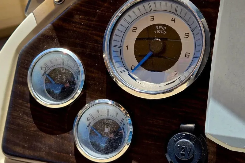 Slide: The Image of Dashboard gauges of a 2019 Starcraft EX 20 C boat, showing RPM and fuel levels. - 21