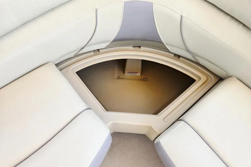 Slide: The Image of Interior seating of 2019 Starcraft EX 20 C boat, featuring beige upholstery and storage compartment. - 27