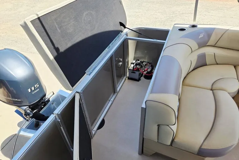 Slide: The Image of 2019 Starcraft EX 20 C pontoon boat interior with Yamaha 115 engine and seating area. - 32