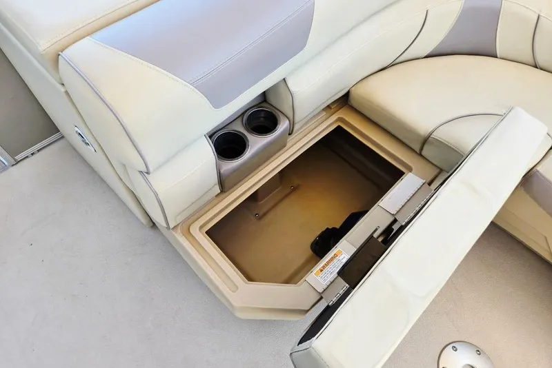 Slide: The Image of 2019 Starcraft EX 20 C boat seat with open storage compartment and cup holders. - 36
