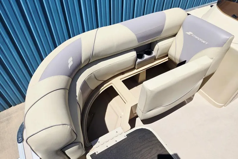 Slide: The Image of 2019 Starcraft EX 20 C boat interior with beige seating and cup holders. - 9