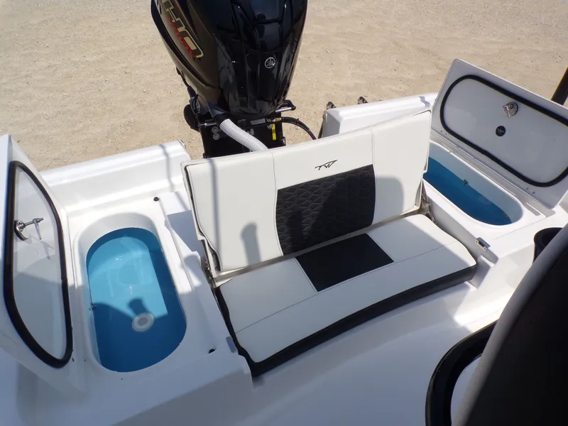 Slide: The Image of 2026 Tidewater 2210 Carolina Bay boat rear with seating and storage compartments. - 40