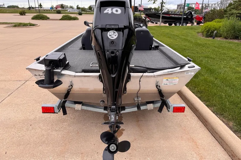 Slide: The Image of 2019 Lowe Skorpion 16 boat with outboard motor on a trailer in a parking lot. - 15