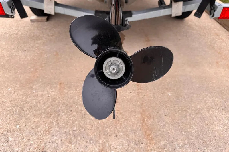 Slide: The Image of Close-up of a 2019 Lowe Skorpion 16 boat propeller on a trailer. - 16