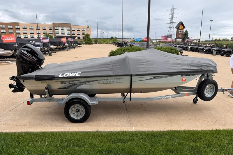Slide: The Image of 2019 Lowe Skorpion 16 boat with cover on trailer, parked outdoors. - 19