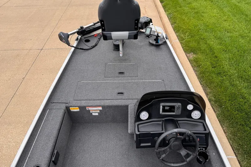 Slide: The Image of 2019 Lowe Skorpion 16 boat interior with steering console and seating. - 2