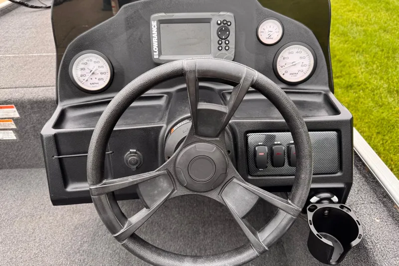 Slide: The Image of 2019 Lowe Skorpion 16 boat dashboard with steering wheel and gauges. - 8
