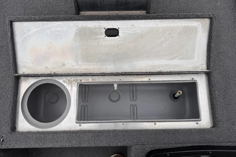 Slide: The Image of 2019 Lowe Skorpion 16 boat storage compartments with open lids, showcasing interior design. - 9