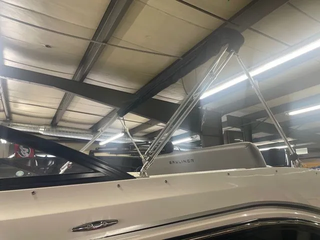 Slide: The Image of 2023 Bayliner DX 2000 boat in a storage facility. - 8