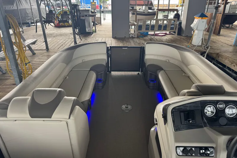 Slide: The Image of 2023 Avalon LSZ 2585 RL pontoon boat interior with plush seating and illuminated cup holders. - 3
