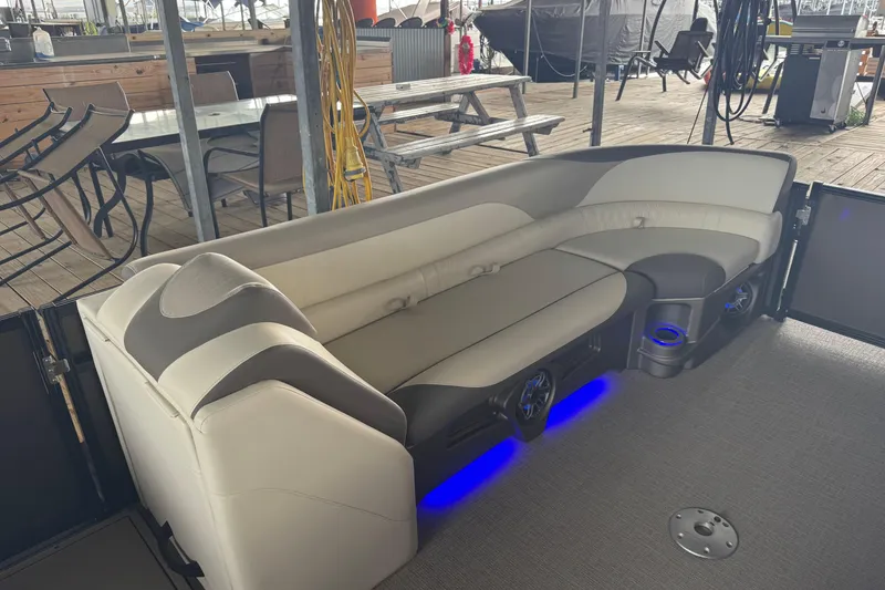 Slide: The Image of Luxurious seating on 2023 Avalon LSZ 2585 RL pontoon boat with ambient blue lighting. - 4