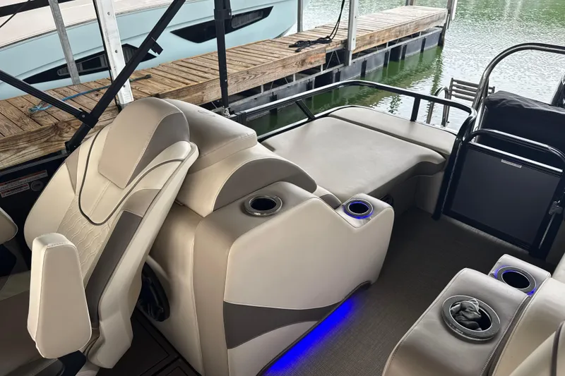 Slide: The Image of 2023 Avalon LSZ 2585 RL pontoon boat interior with beige seating and cup holders. - 6