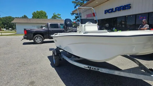 Slide: The Image of 2026 Mako Pro Skiff 13 CC on trailer outside Polaris store. - 10