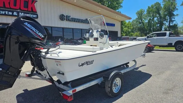 Slide: The Image of 2026 Mako Pro Skiff 13 CC boat parked outside a store. - 4