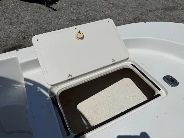 Slide: The Image of Open storage compartment on a 2015 Carolina Skiff DLV 218 boat. - 12