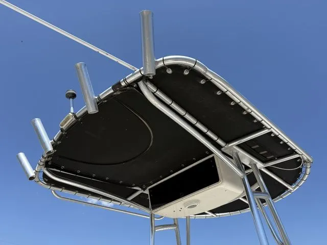 Slide: The Image of T-top of a 2015 Carolina Skiff DLV 218 boat against blue sky. - 6