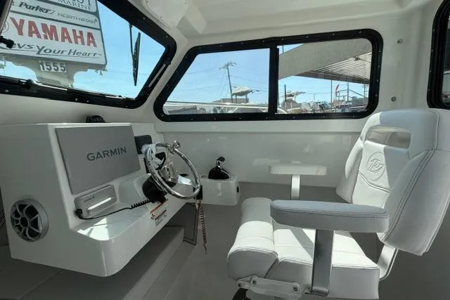 Slide: The Image of Interior of 2026 Parker 227 Explorer boat with Garmin navigation system and Yamaha branding. - 6