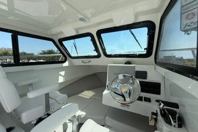 Slide: The Image of Interior of 2026 Parker 227 Explorer boat with modern steering and seating. - 7