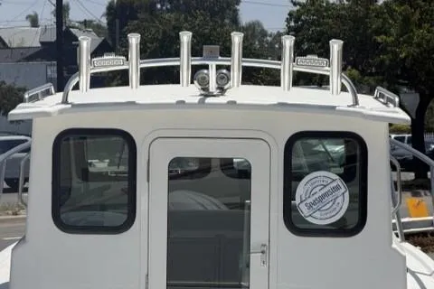 Slide: The Image of Parker 227 Explorer 2026 boat with rod holders and cabin door. - 8