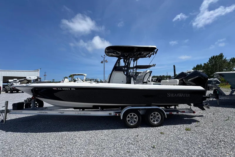 The Image of 2019 ShearWater 270 Carolina Flare boat on trailer under clear blue sky. - 1