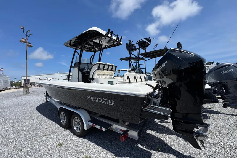 Slide: The Image of 2019 ShearWater 270 Carolina Flare boat on trailer, featuring Mercury outboard engine. - 12