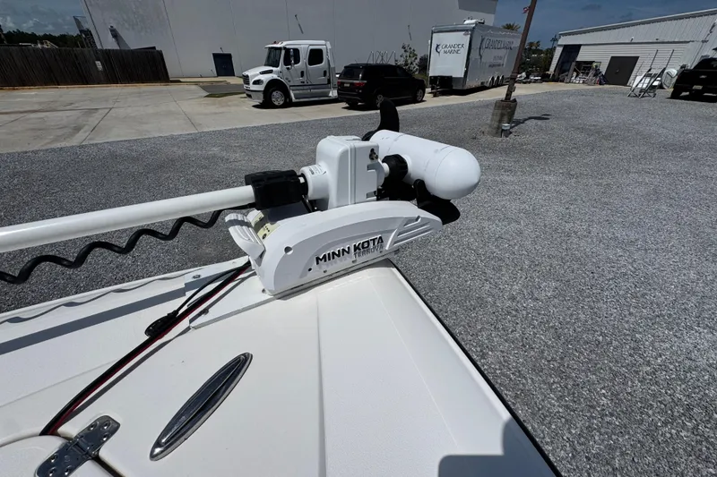 Slide: The Image of Minn Kota trolling motor on 2019 ShearWater 270 Carolina Flare boat in parking lot. - 16