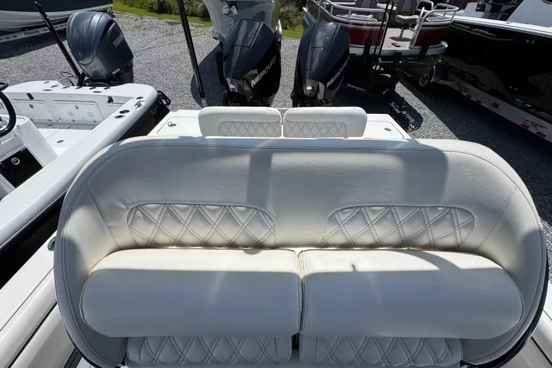 Slide: The Image of 2019 ShearWater 270 Carolina Flare boat with white cushioned seating and dual outboard motors. - 23