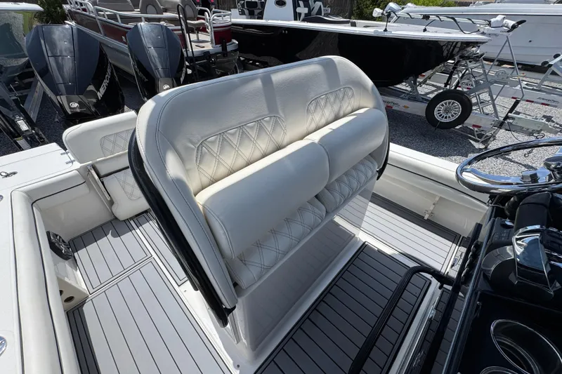 Slide: The Image of 2019 ShearWater 270 Carolina Flare boat interior with white cushioned seating and sleek design. - 24