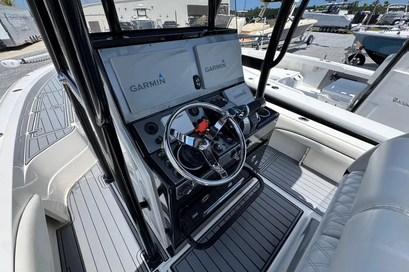 Slide: The Image of 2019 ShearWater 270 Carolina Flare boat cockpit with Garmin navigation system and sleek steering wheel. - 25