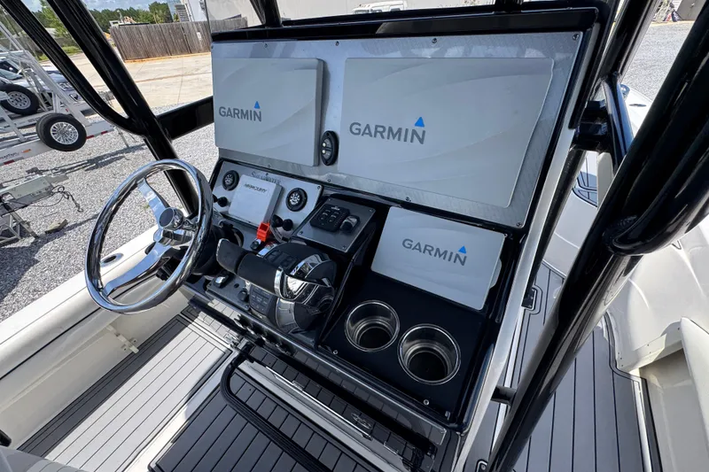 Slide: The Image of 2019 ShearWater 270 Carolina Flare boat console with Garmin navigation displays and steering wheel. - 27