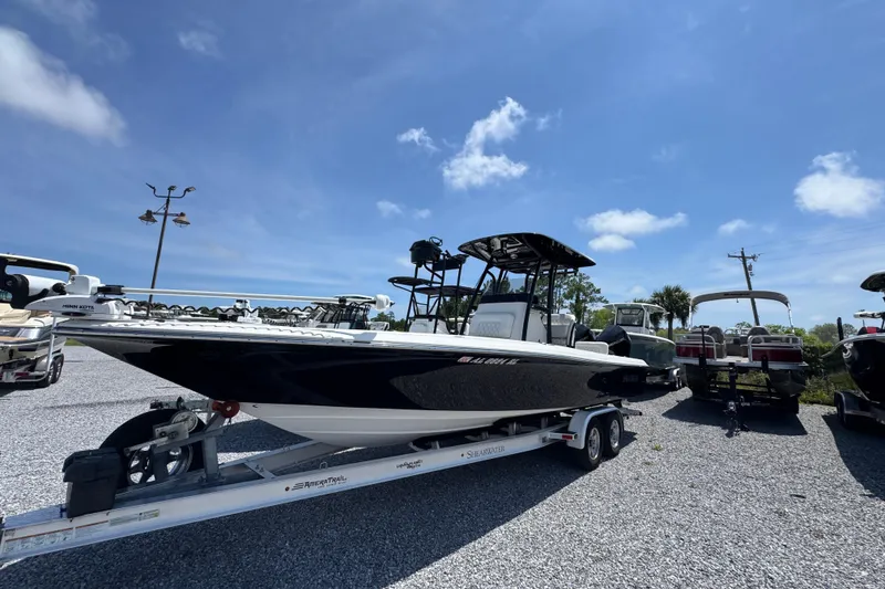 Slide: The Image of 2019 ShearWater 270 Carolina Flare boat on trailer under clear blue sky. - 3