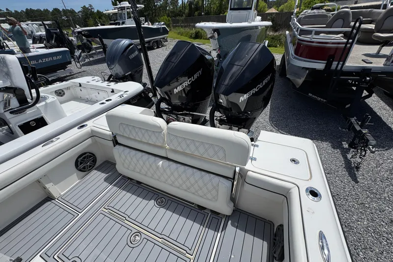 Slide: The Image of 2019 ShearWater 270 Carolina Flare boat with dual Mercury engines, showcased in a marina setting. - 32
