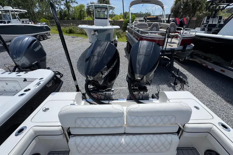 Slide: The Image of 2019 ShearWater 270 Carolina Flare boat with dual Mercury engines, parked among other boats. - 33