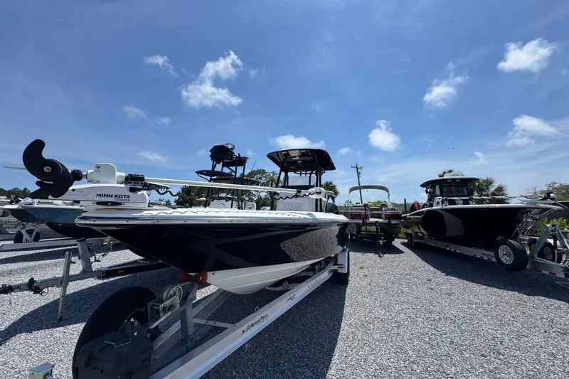 Slide: The Image of 2019 ShearWater 270 Carolina Flare boat on trailer under clear blue sky. - 4