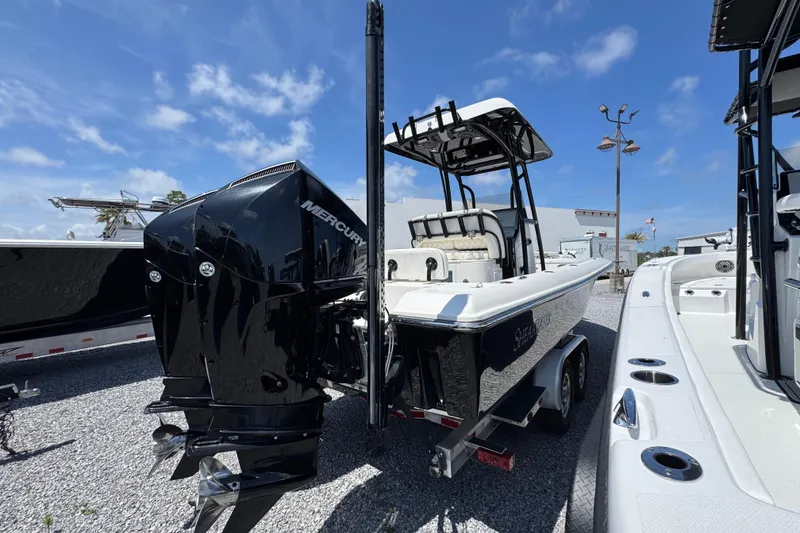 Slide: The Image of 2019 ShearWater 270 Carolina Flare boat with Mercury engine, parked on gravel. - 8