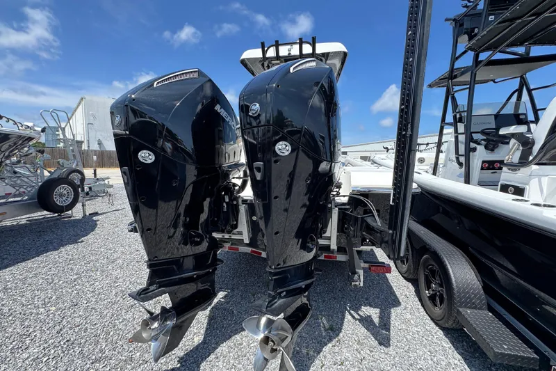 Slide: The Image of Twin outboard motors on a 2019 ShearWater 270 Carolina Flare boat, parked on gravel. - 9