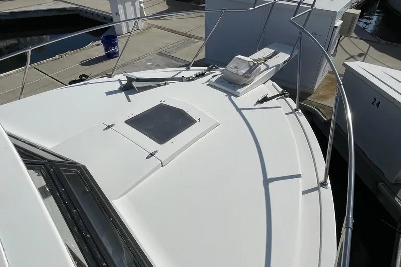 Slide: The Image of 1987 Bertram 28 Flybridge boat deck with railing and hatch, docked at marina. - 18