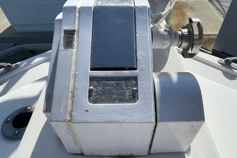 Slide: The Image of 1987 Bertram 28 Flybridge boat winch, close-up view, showing metal components and surface details. - 21