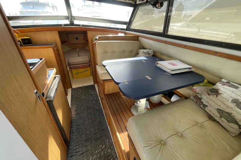 Slide: The Image of Interior of 1987 Bertram 28 Flybridge with cozy seating and dining area. - 22