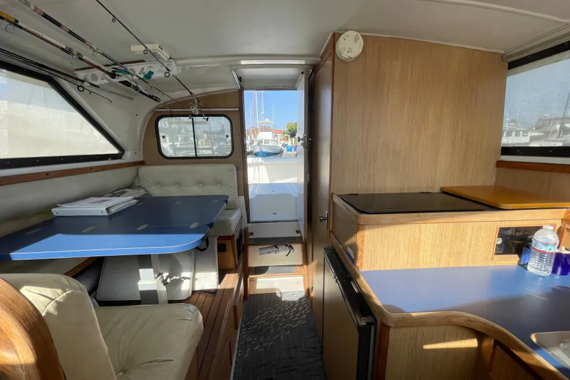 Slide: The Image of Interior of 1987 Bertram 28 Flybridge boat with dining area and kitchenette. - 23