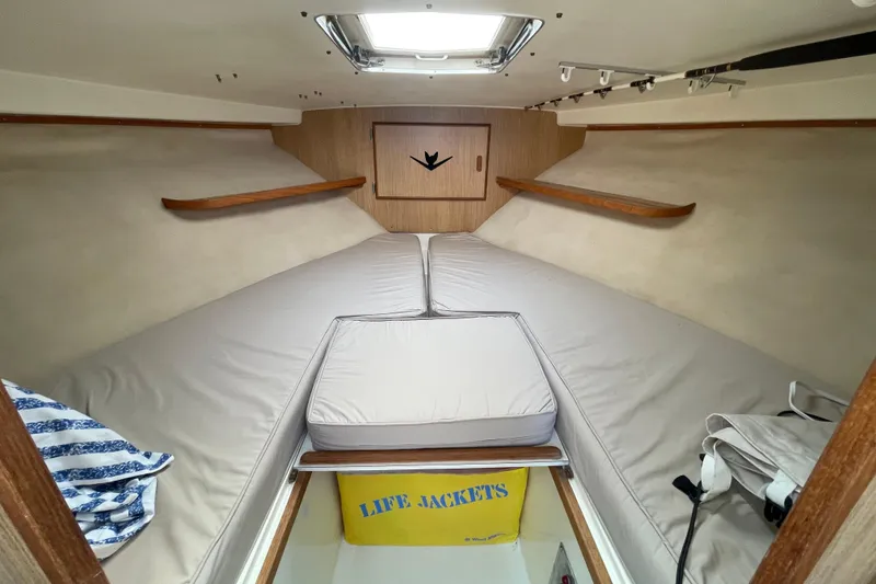 Slide: The Image of Interior cabin of 1987 Bertram 28 Flybridge with cushions and life jackets. - 32
