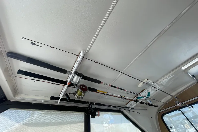 Slide: The Image of Fishing rods stored on the ceiling of a 1987 Bertram 28 Flybridge boat. - 36